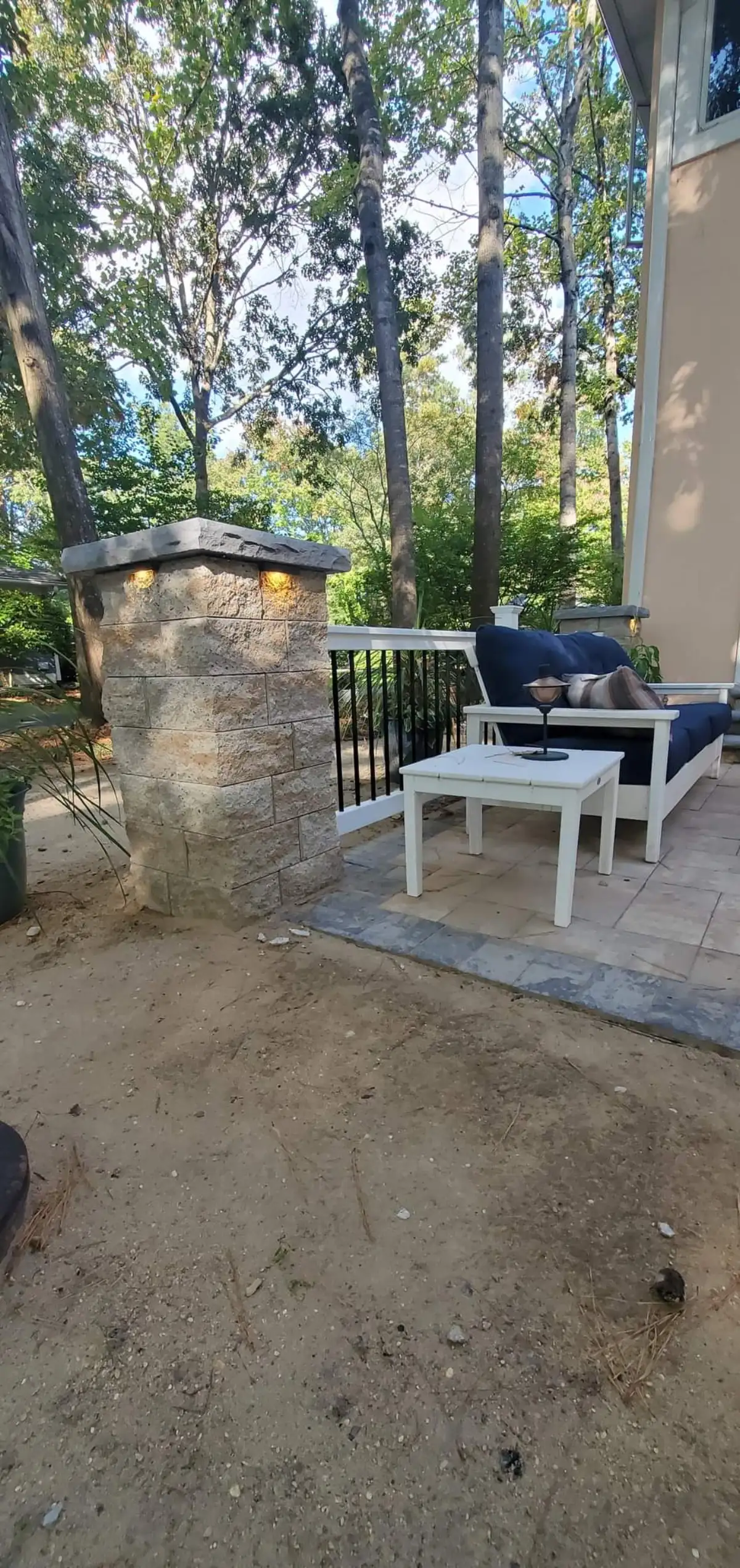 Custom fire pit with stone surround and seating wall in Sussex County Delaware