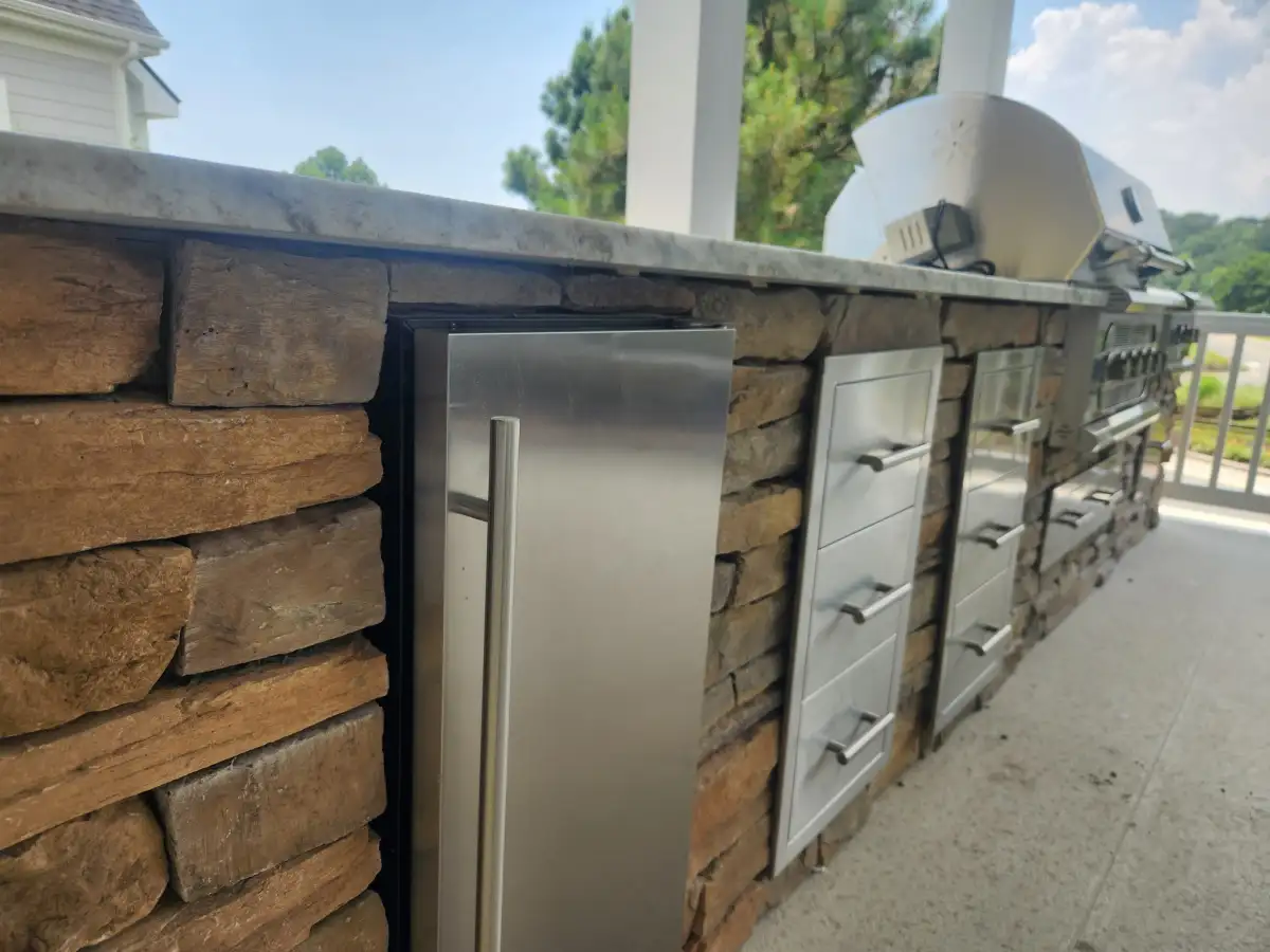 Custom outdoor kitchen with built-in grill and stone countertops in Sussex County Delaware
