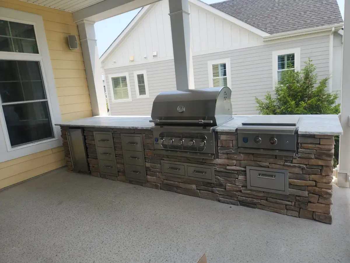 Custom outdoor kitchen design with stone veneer and countertop in Delaware