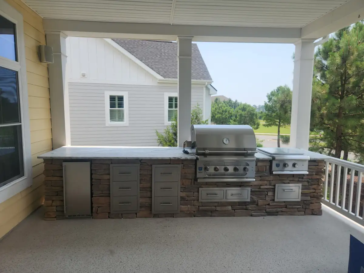 Outdoor kitchen bar with countertop seating in coastal Delaware