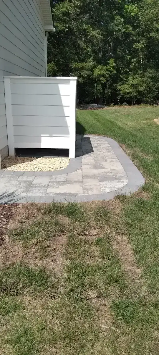 Custom fire pit with paver surround and seating wall in coastal Delaware