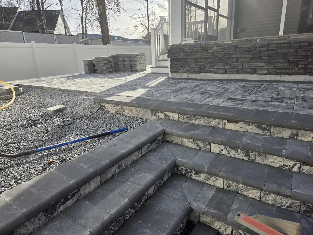 Paver walkway with border detail connecting patio areas in Delaware