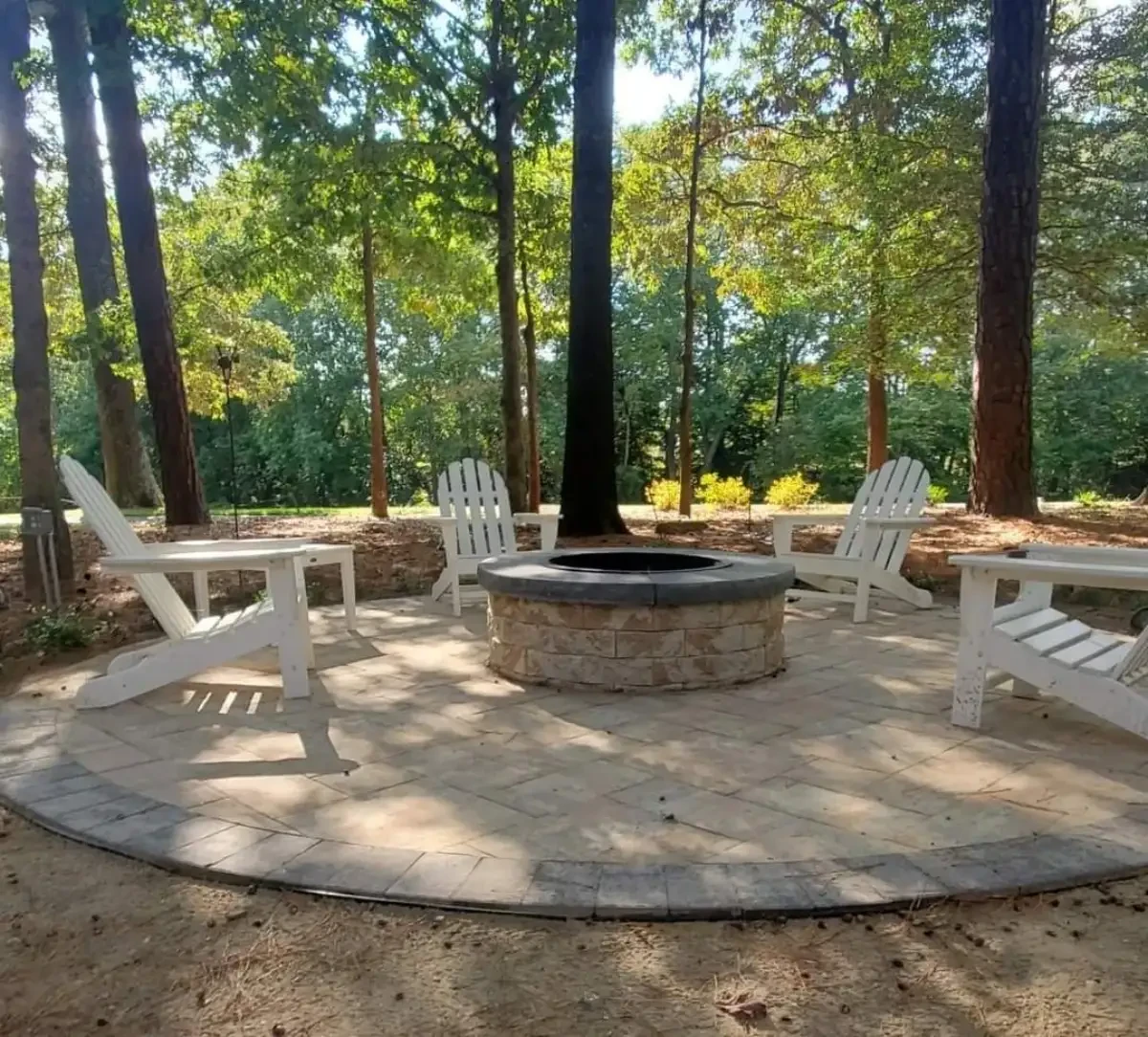 Round fire pit with chairs on a circular paver patio
