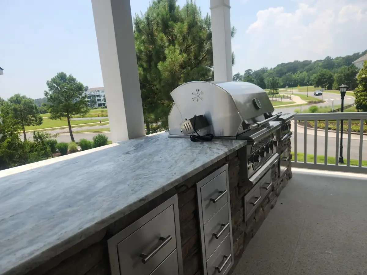 Outdoor kitchen countertop, pizza oven, and grill