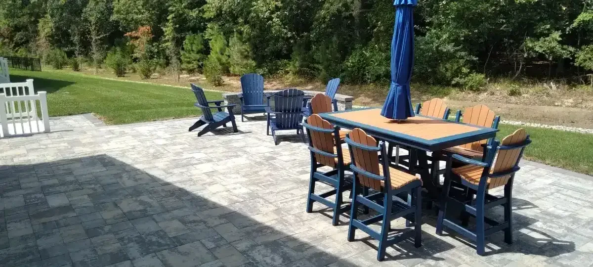 Paver patio with an outdoor dining table and chairs